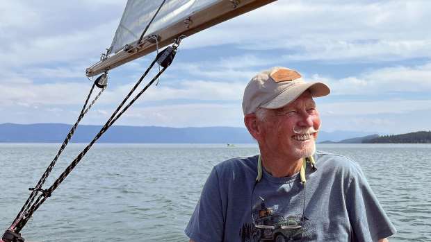 A smiling Robin Lee Graham sails on Flathead Lake.