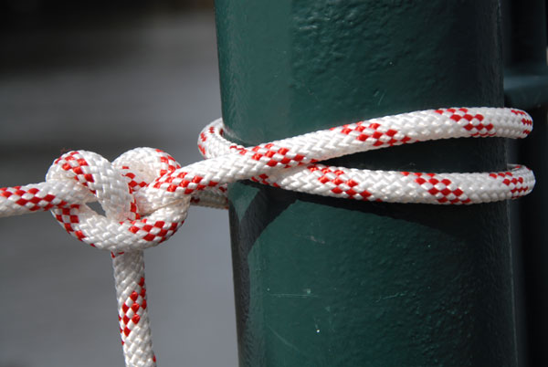 A knot tied around a green post