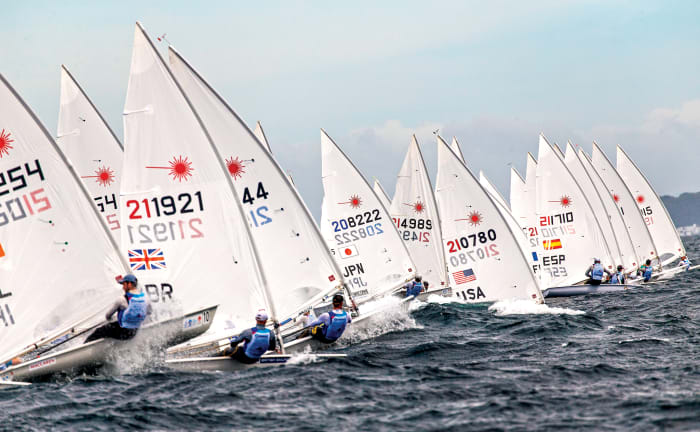 The men’s Laser class blasts off the line at the Enoshima portion of the Hempel World Cup