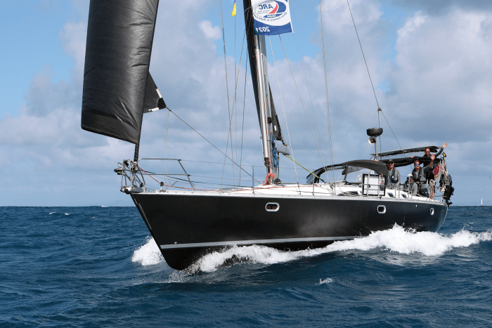 The Jeanneau Sun Odyssey 45.5 Go East roars across the finish line under full sail