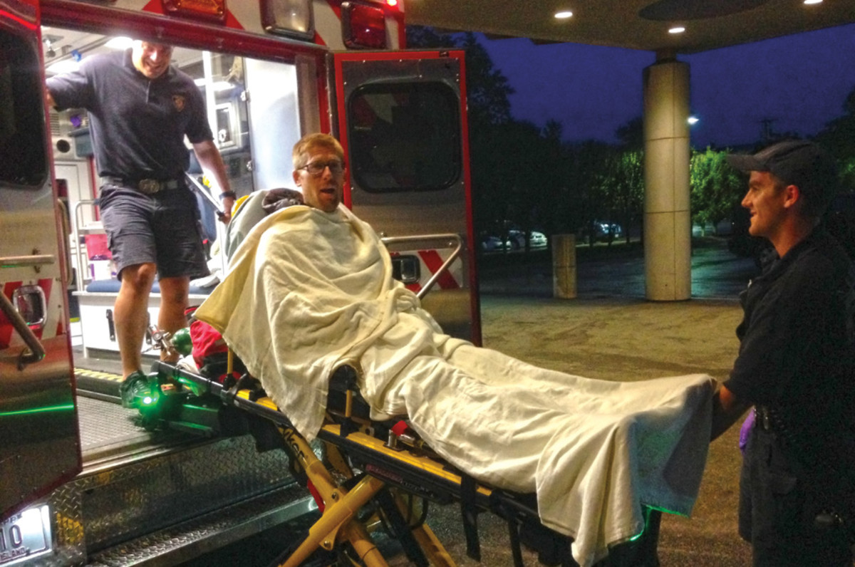 The author gets tucked in before his ambulance ride from the dock to a hospital in Newport
