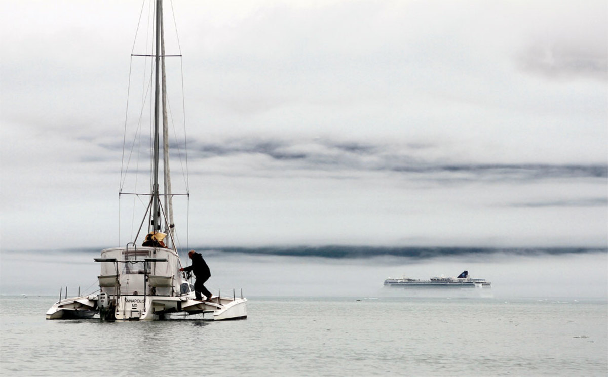 Out of the mist in Glacier Bay, a cruise ship emerges to break the magic spell of the crew’s solitary reverie