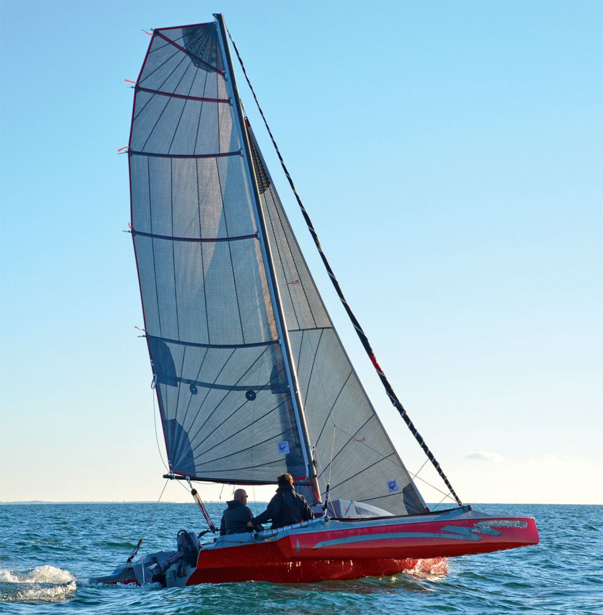 The lack of backstay makes it possible for this tri to carry plenty of roach on its square-top mainsail: note the radial pattern of its laminated panels and full-length battens