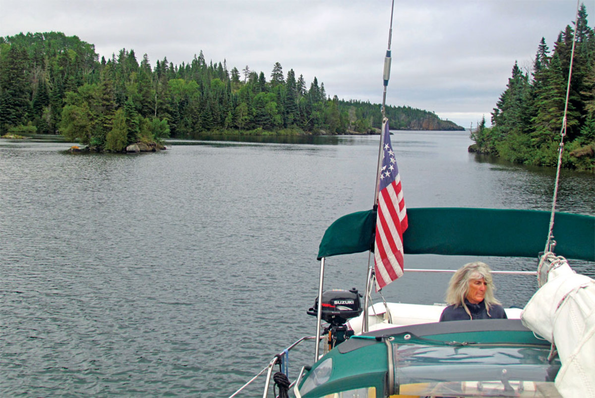 Jennifer cons their boat through the narrows leading to Chippewa Harbor
