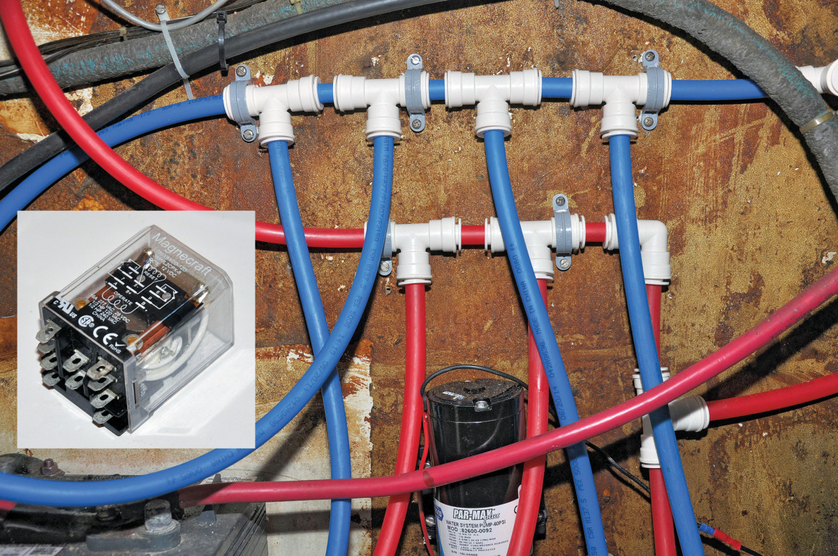 The author replaced all the old tubes and re-routed many to make them easier to inspect. Red tubing is hot water and blue is cold. Inset: The latching relay keeps the shut-off valve closed, even when the bilge float switch returns to normal. It can be de-activated by switching the relay off for a second, then switching it back on