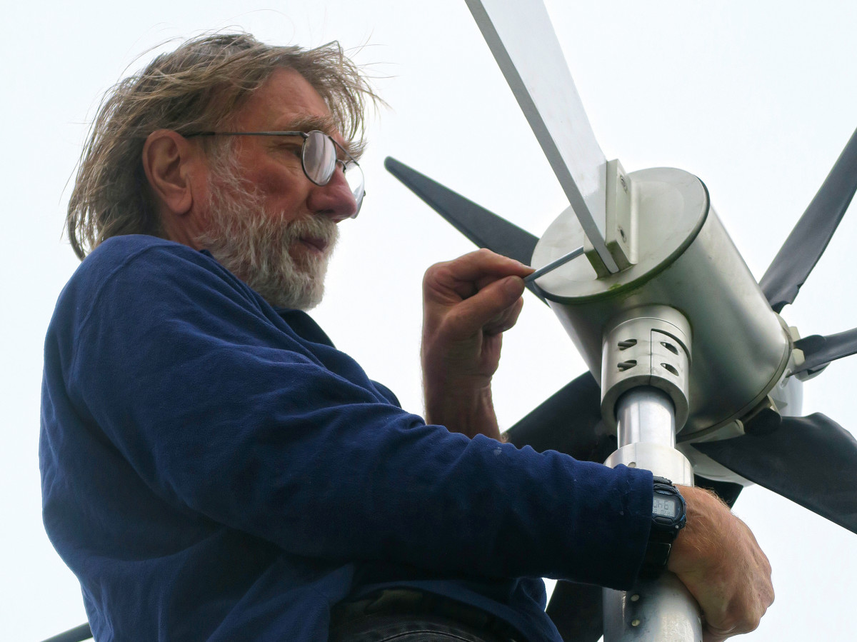The author repairs the tail section of his wind generator