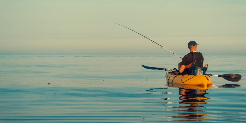 Kayak fishing on calm and sunny seas