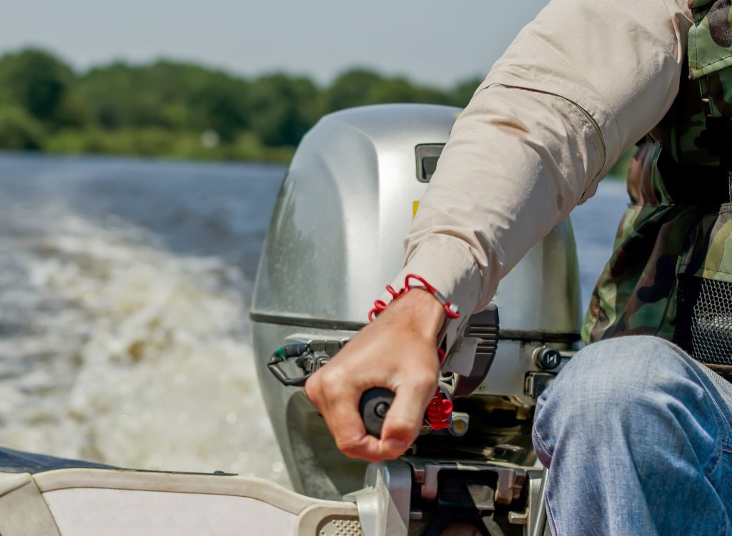 Man operating a motor boat on water