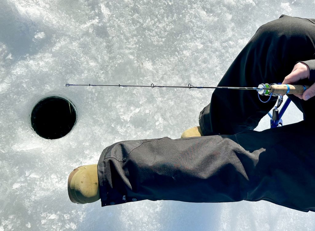 Man ice fishing with a rod