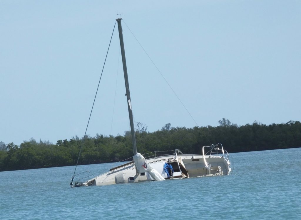 Capsized sailboat in the water