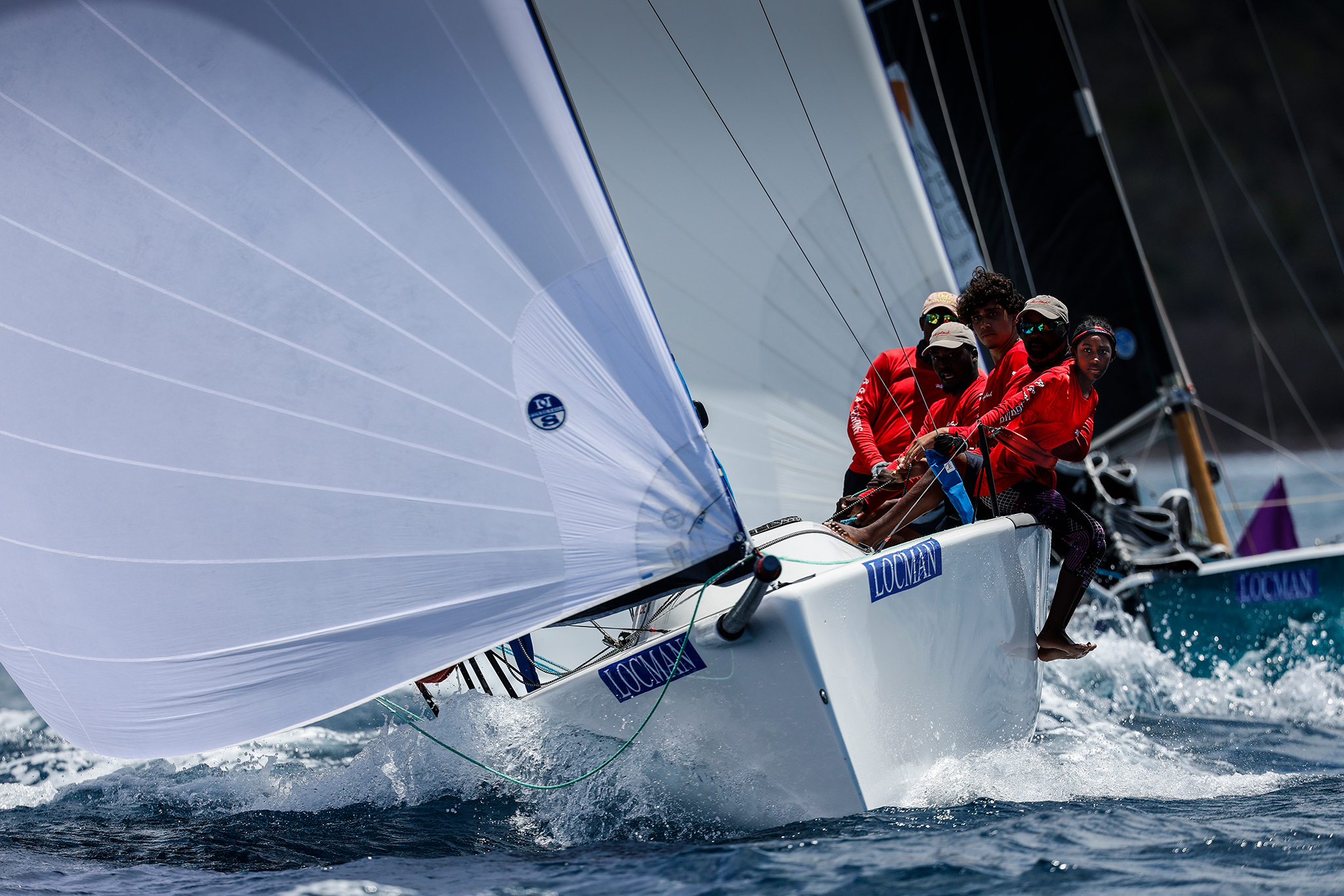 The crew of the Melges 24 Whiplash hikes out at Antigua Sailing Week.